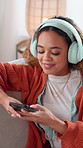 Mobile, headphones and woman in home for music, streaming service or dance to sound. Phone, audio and happy girl listening to song in living room, radio app and relax with online playlist on internet