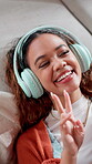 Influencer, peace sign and woman with headphones, vlog and live stream for fans, laugh and creative. Online, content creation and person with smile for social media, blow kiss and video in house
