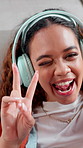 Influencer, face and woman with headphones, vlog or blowing kiss for audience, happy and live stream. Online, content creation and person with peace sign for social media, pov and video in house