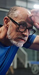 Exercise, sweating and tired with man on padel court for competition, practice or training. Exhausted, fitness and tennis with mature person wiping brow at sports venue for game or match fatigue