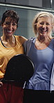 Face, hug and women at indoor court for padel match, training or cardio workout together. Fitness, athletes and mature female friends embracing for sports game, practice or exercise for wellness.
