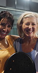 Sports, hug and face of women at indoor court for padel match, training or cardio workout together. Portrait, athletes and mature friends embracing for fitness game, practice or exercise for wellness
