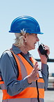 Shipping yard, woman and radio for supply chain planning, speaking and export management. Communication, mature person and talking for shipment, industrial distribution and logistics schedule outdoor