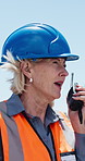 Construction, woman or communication on site with radio for building instructions, report or update. Contractor, mature person outdoor or walkie talkie for discussion, risk assessment advice or chat.
