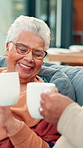 Home, coffee and old couple on sofa, cheers and bonding together with love, relax and smile. Retirement, apartment and senior woman with mature man, herbal tea and toast with romance and caffeine