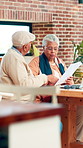 Document, table or senior couple talking with insurance policy, health savings or financial debt. Retirement, review or old people argue with hospital bill for claim rejection, coverage info or home