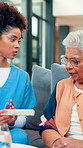 Old woman, nurse and advice with pills for consulting and talk for daily prescription on couch. Female person, caregiver and support in retirement for health, patient and planning for treatment