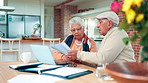 Senior couple, reading and document at house for finance, budget planning and mortgage bills. Elderly people, paperwork and laptop for asset management, retirement application and financial expenses 