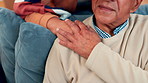 Empathy, hand and shoulder with old couple in home living room together for love or support. Security, trust or wellness with senior people in apartment for bonding, commitment or connection