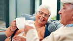 Cheers, coffee and elderly couple on sofa in home with bonding, love and marriage together. Happy, toast and senior man with woman drinking warm beverage in living room on weekend at apartment.