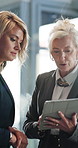 Tablet, discussion and business women in office with collaboration for finance review with budget. Digital technology, planning and manager with financial advisor for investment proposal in workplace
