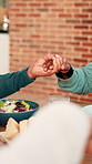 Dinner, holding hands and praying with family in home dining room for grace or thanksgiving. Faith, meal blessing and prayer with people at table in apartment together for belief, brunch or religion