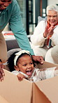 Happy family, dad and pushing child with box in new home for fun ride, moving in or childhood. Father, daughter and playing with kid in cardboard with grandparents for fresh start together in house