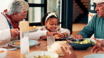 Grandparents, child and eating lunch for thanksgiving celebration, meal and serving burger. Girl, grandmother and grandfather share food in home, generations and happy family talking in dining room