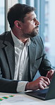 Thinking, business and man with laptop in office for accounting, finance report and statistics. Male person, pc and graphs on documents with data analysis, financial evaluation and solution for audit