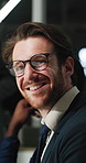 Night, face and man in office with smile, confidence and pride in business meeting. Working late, glasses and corporate employee in agency with happiness, team or experience in planning session.
