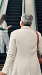 Back, escalator and woman walking with luggage in airport for international business trip or travel. Commute, departure and suitcase with employee person in terminal for flight or opportunity