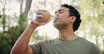 Drinking water, fitness and hiking with happy man in forest for adventure, hobby or travel. Bottle, exercise and hydration with hiker person outdoor in nature for holiday, sightseeing or tourism