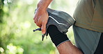 Man, hands and stretching with legs in forest for workout preparation or outdoor exercise. Fitness, male person or runner getting ready with foot warm up for trekking, hiking or training in nature