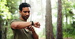 Athlete, man and check smart watch in nature for fitness app, tracking progress and start timer. Male person, wristwatch and running for exercise, monitor heart rate and step count of cardio training
