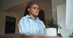 Black woman, computer and typing with remote work from home, glasses and review with low angle. African person, freelance writer and creative with project management, editing and pc at apartment