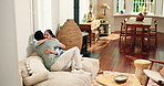 Sofa, couple and hug with smile for bonding, chat together and healthy relationship in living room. Happy people, man and woman or partner for connection, love or commitment with marriage in home