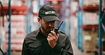 Man, security and warehouse surveillance with radio for inventory safety, inspection or check. Male person, officer or bodyguard walking with signal for communication or supply chain defense in depot