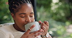 Black woman, relax and drinking with mug for coffee, warm beverage or morning comfort in home. Happy, female person or calm sensation with cup, scent or caffeine for energy, aroma or taste in house