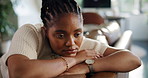 Black woman, depression and thinking on sofa in home, sad and tired with mental health in living room. African person, memory and anxiety on couch, stress and reflection in lounge at apartment