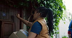 Front door, courier and knock with black woman at house for shipping, distribution service and ecommerce parcel. Online shopping package, delivery and cargo with person outdoor for supply chain