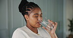 Glass, drinking water and smile with black woman in kitchen of home for detox drinks, mineral hydration and health. Electrolytes, wellness and aqua with person in apartment for liquid and beverage