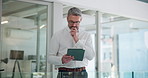 Businessman, tablet and thinking in office with finance report, budget review and statement. Mature, accountant and reading with tech at firm for financial audit and company performance evaluation