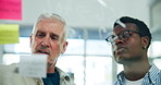 People, talk or brainstorming at glass window with sticky note, financial plan or business mentorship. Mature man, employee and discussion in office with budget strategy, problem solving or training.