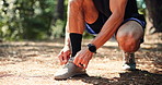 Running, tie laces and shoes with man in nature for sports athlete, workout and wellness. Sneakers, health and race training with legs of person outdoor for exercise, cardio challenge and runner