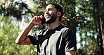 Fitness, phone call and man in nature for exercise update, communication and low angle. Park, person and happy runner with mobile for health conversation, wellness and sports with connection outdoor
