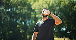 Man, walk or drink water in nature with fitness for sports hydration, workout or exercise break. Bokeh, space or thirsty person outdoor with beverage for electrolytes, training recovery and wellness.