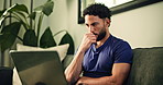 Laptop, thinking and typing with man on sofa in living room of home for remote work solution. Computer, planning and reading with freelance employee in apartment for report, research or review