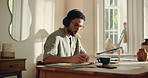 Writing, notebook and man in home office for planning, agenda and schedule for ideas for article. Thinking, journalist and freelancer with laptop, headphones and inspiration for remote work with tech