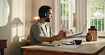 Creative, man and video call on laptop at house for discussion, question source and feedback. Male person, remote work and headphones for webinar, writing notes and information on article publication