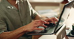 Remote work, typing and hands of man on laptop for article, website content and copywriting. Freelancer, home and person on computer for online publishing, editing news review and magazine story