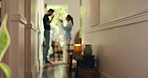 Frustrated couple, fight and dispute with home for argument, conflict or separation in hallway. Angry, man and woman shouting with toxic relationship for breakup, divorce or confrontation in house
