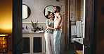 Couple, hug or kiss in bathroom at night, caring relationship or pointing for washroom cleanliness. Connection, love or happy people with support in home, evening embrace and appreciation for hygiene