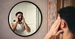 Mirror, skincare and man in bathroom in home for health, wellness or facial routine in morning. Beauty, cosmetics and male person with reflection for dermatology treatment for hygiene in apartment.