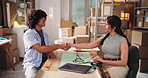 Business people, logistics and laptop with handshake for agreement, deal or b2b partnership. Businessman, woman or shaking hands with boxes or computer for shipping meeting, trust or courier service