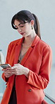 Office, online and business woman with phone in lobby for communication, typing message and email. Creative agency, startup and person on smartphone for reading notification, connection and contact