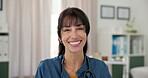 Medical, face and woman in clinic with smile, confidence or career pride in healthcare. About us, happiness or doctor in hospital with stethoscope, general practitioner or experience in wellness.