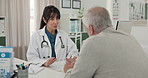 Consultation, doctor and old man in clinic, healthcare and conversation with feedback for treatment. Pensioner, patient and woman in office, medical service or appointment with discussion or support