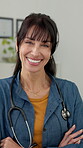 Face, doctor or laugh with arms crossed in clinic for medical service, cardiology expertise or about us. Healthcare, mature woman and happy in hospital for health support, career pride and integrity
