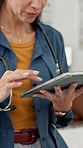 Scroll, doctor and hands of woman on tablet in office for online research, medical service and telehealth. Healthcare, clinic and person on digital tech for report, diagnosis and website for medicare