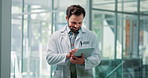Happy, doctor and man in hospital, tablet and typing with connection, internet and healthcare. Person, medical service and professional in clinic, tech and research with email for online schedule